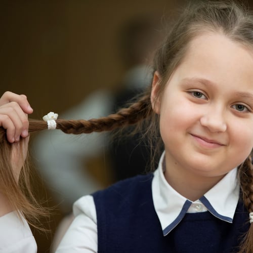 Young girl looks happily into camera